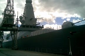 HMS Daring alongside...
