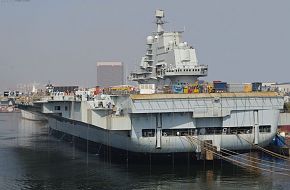 Full view of the new Chinese PLAN aircraft carrier from the port quarter