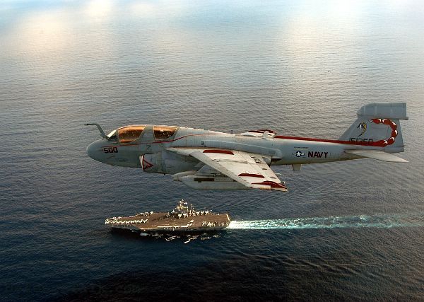 A Classis Picture of a Prowler passing an aircraft carrier parallel