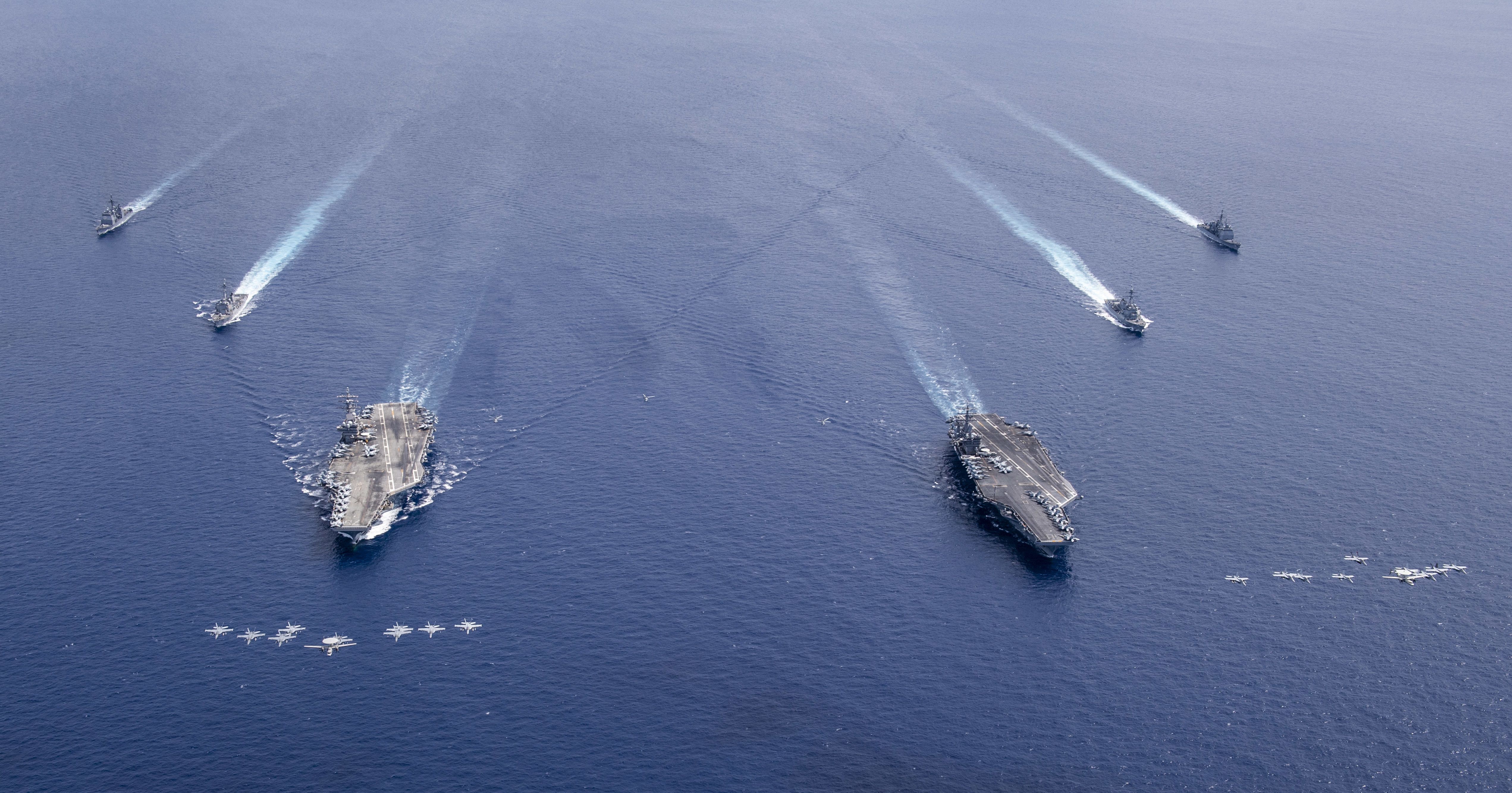 Aircraft from CVW 5 and 17 fly in formation over the Nimitz Carrier Strike Force