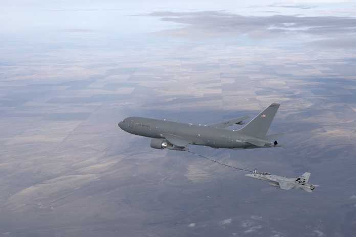 A KC-46A Pegasus refuels an FA-18 Hornet with its hose and drogue system.