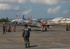 An EMB-314 from TNI-AU and a Garuda Indonesia 737-800 at DPS.jpg