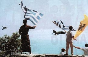 Greek F-4E PhantomII in low flight while Greek Monk and palmers in Mount At