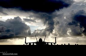 An F/A-18E Super Hornet sits aboard the Nimitz-class aircraft carrier USS R