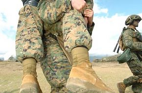 oldier carries his wounded comrade - RIMPAC 2006