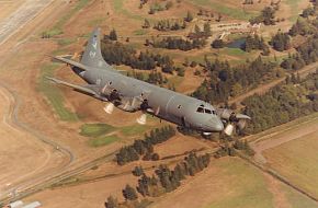 CP-140 Aurora over golf course