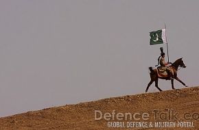 Pakistani soldier holds a national flag - IDEAS 2006, Pakistan