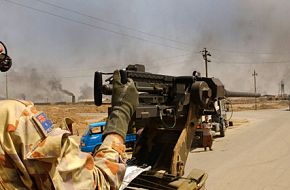 A manned 0.50 cal machine gun on an Aussie ASLAV in Iraq