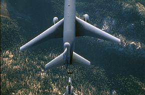 a KC-10 Extender (top) refuels a F-22 Raptor.