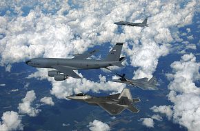 KC-135 Refueling F-15 While F-22 Waits