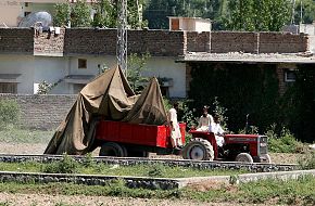 Tractor trolley carries the wreckage of a helicopter