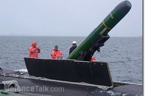 A MK-48 Torpedo being loaded into a Collins Class Submarine