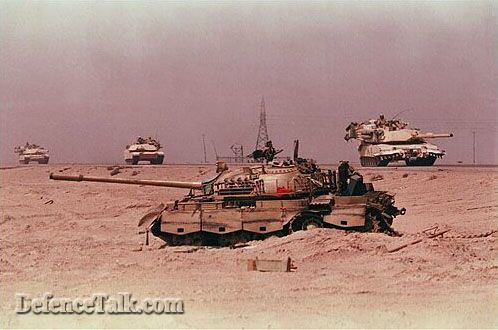 Abrams Tank in front of a destroyed T-72 Tank.
