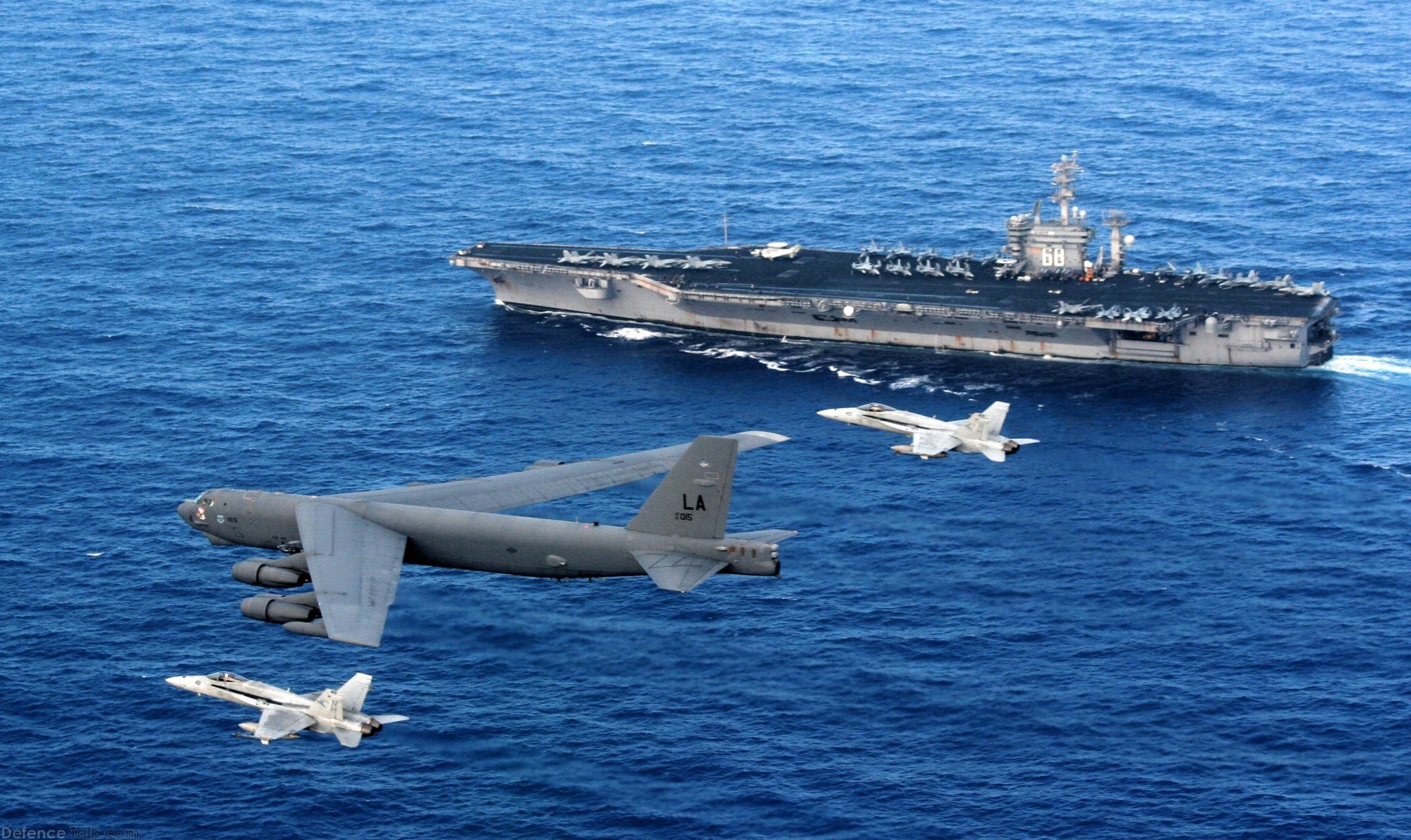 B-52 & F/A-18E fly past USS Nimitz