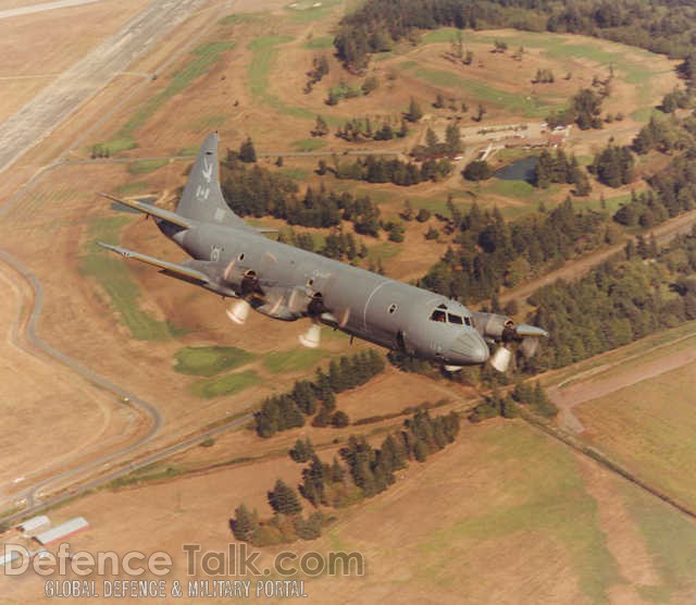 CP-140 Aurora over golf course