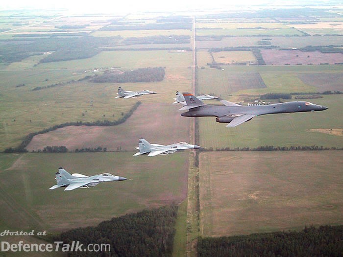 Four german Mig-29 escort a B1B-bomber.