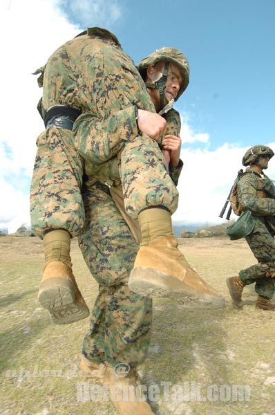 oldier carries his wounded comrade - RIMPAC 2006