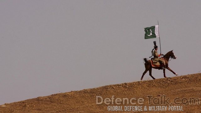 Pakistani soldier holds a national flag - IDEAS 2006, Pakistan