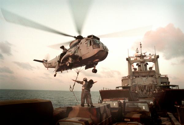 RAN Seaking lifts equipment off HMAS Tobruk