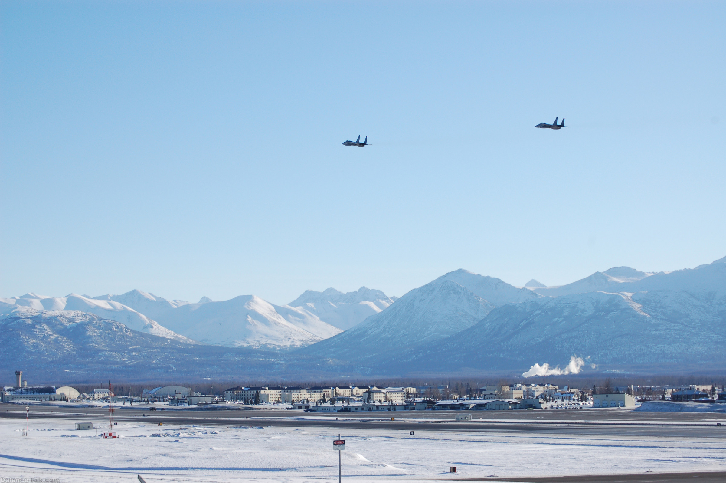 Two F-15E Strike Eagles fly over