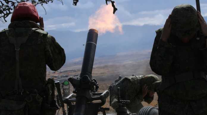 firing a 120-millimeter mortar firing a 120-millimeter mortar