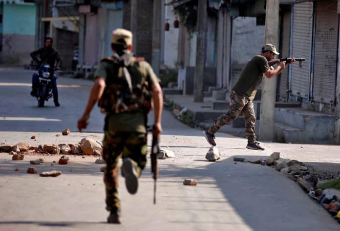 An Indian policeman fires tear gas shells towards the demonstrators during an anti-India protest in Srinagar